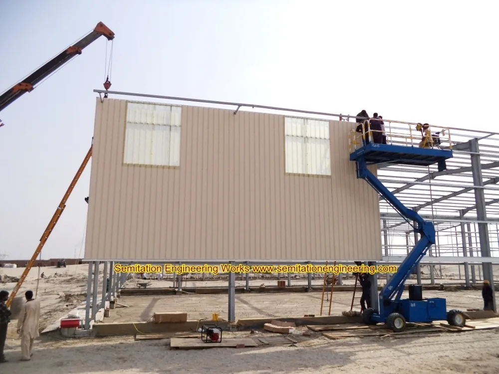 Historical construction photo showing installed cladding on structural steel